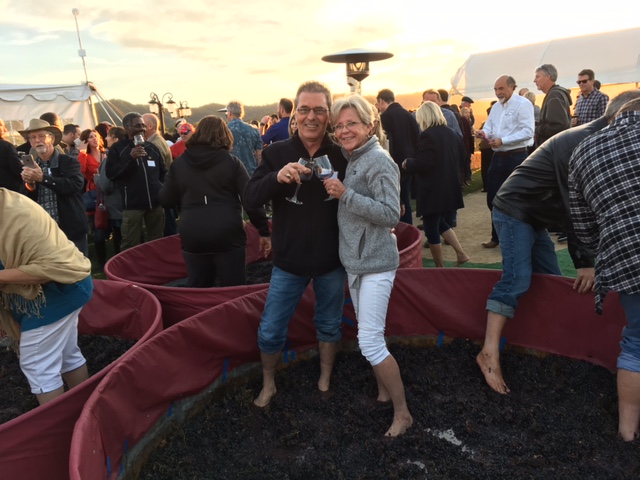 Enjoying themselves immensely while stomping grapes and imbibing of the finished product, Columbus Serbs, Dave and Sharon Tumbas, pause for a photo.